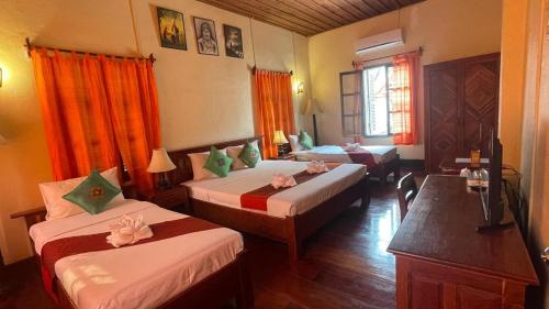 a hotel room with two beds in a room at Villa Saykham in Luang Prabang
