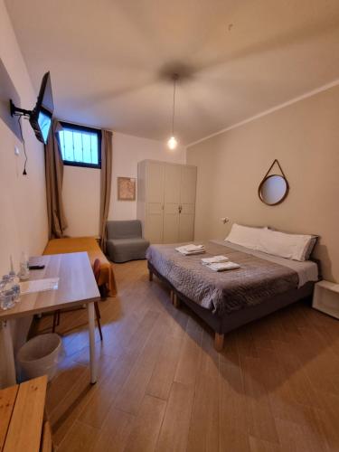 a bedroom with a bed and a table in it at LIMO to Host in Roccaromana