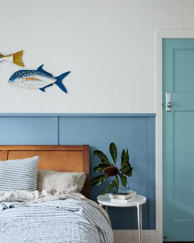 a bedroom with a bed and a fish on the wall at Bruns Surf Shack in Brunswick Heads