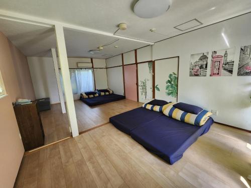 a bedroom with two beds in a room at Peace House Isonoura in Wakayama