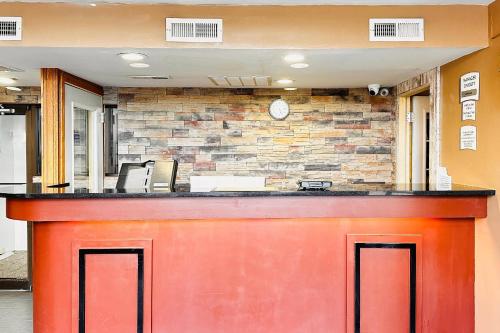 a red bar in a lobby with a brick wall at Quality Inn St Paul-Minneapolis-Midway in Saint Paul