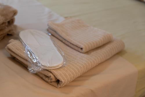 a cell phone sitting on top of a pile of towels at Villa ADAM in Artemida