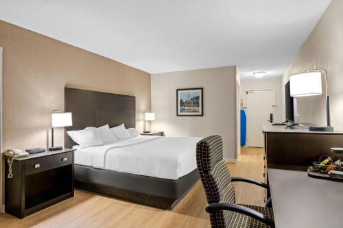 a hotel room with a bed and a desk at Quality Inn & Suites in Grayling