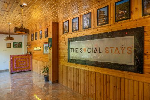 a building with a sign that reads the social stays at The Social Stays Tirthan in Bandal