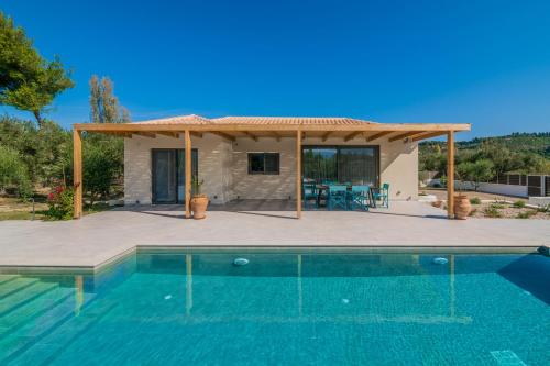 a villa with a swimming pool and a house at Tsilivi Pandessia Villa in Tsilivi