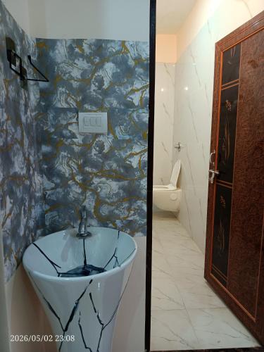 a bathroom with a sink and a toilet at Kedarnath villa in Kakarmatha