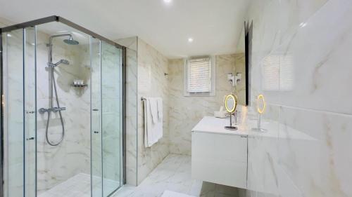 a bathroom with a shower and a glass shower stall at Hotel La Calanque in Cavalaire-sur-Mer