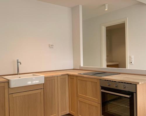a kitchen with a sink and a counter top at Cozy Scandinavian design apartment in Bergen