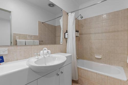 a bathroom with a sink and a bath tub at Comfort Inn & Suites Sombrero in Adelaide