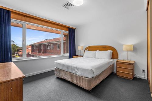 a bedroom with a bed and a large window at Comfort Inn & Suites Sombrero in Adelaide