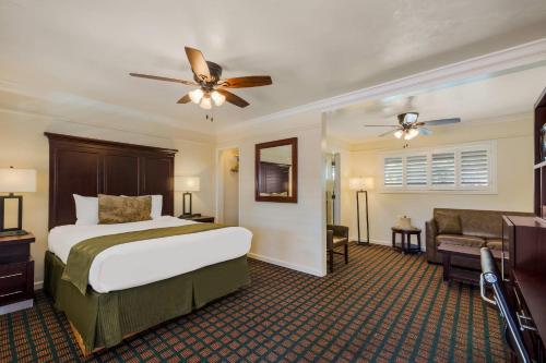 a hotel room with a bed and a couch at Clarion Collection Carmel Oaks Inn in Carmel
