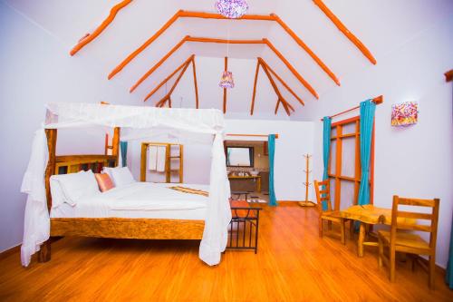 a bedroom with a bed and a table and chairs at Tembo Tarangire Lodge & Camp in Madege