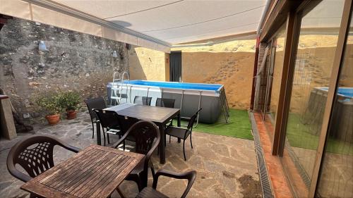 a patio with a table and chairs and a swimming pool at Hauzify I Casa Rourell in El Morell