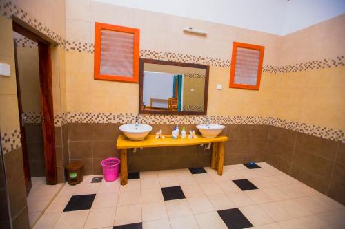 a bathroom with two sinks and a mirror at Tembo Tarangire Lodge & Camp in Madege