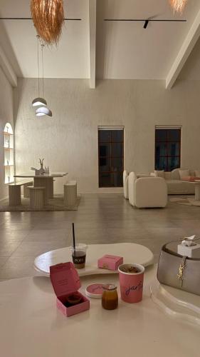 a living room with a table with food on it at Athens Resort in Madīnat an Nahḑah