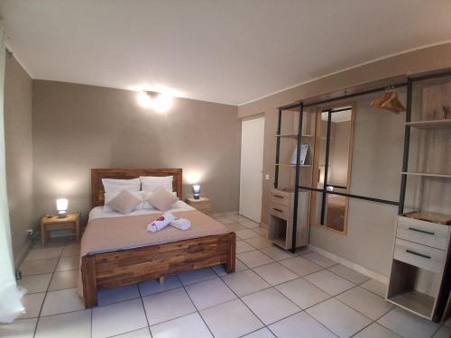 a bedroom with a bed with two towels on it at La Varangue in La Possession