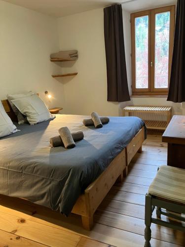 a bedroom with a large bed with two pillows on it at Yak Avenir in Aiguilles