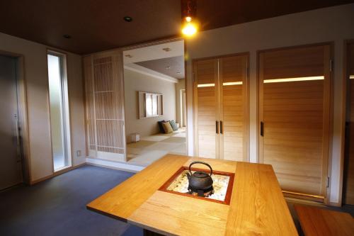 a room with a wooden table with a purse on it at Yanaka Kotobuki Sou in Tokyo