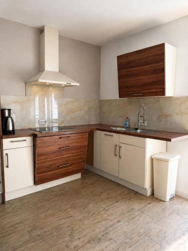 a kitchen with white cabinets and a sink at Pension Lindenhof Drabsch in Neuzelle