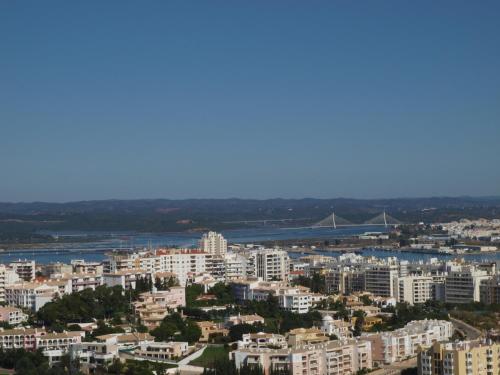 a large city with tall buildings and a clock tower at Apartamentos Jardins da Rocha in Portimão