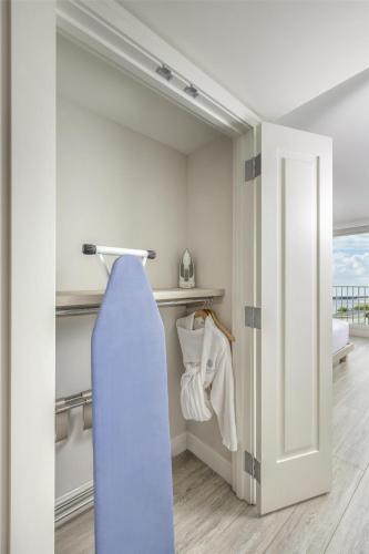 a sliding door in a room with a closet at Sunseeker Resort Florida Gulf Coast, Curio Collection Hilton in Punta Gorda