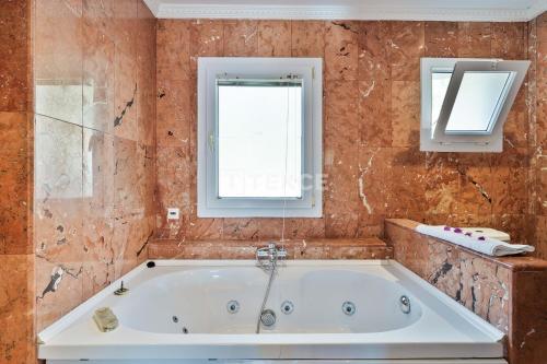 a bath tub in a bathroom with a window at TEKCE Villa Motto N21 in Kaş