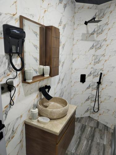 a bathroom with a sink and a mirror at Квартира возле стадиона in Kobuleti