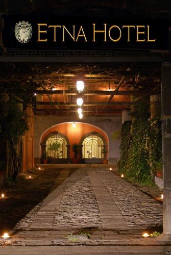 an entrance to an eminem hotel at night at Etna Hotel in Giarre