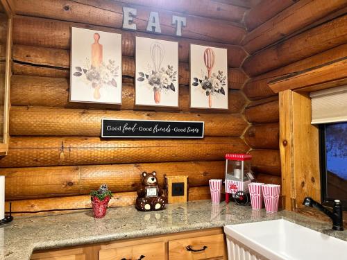 a kitchen counter with a sink in a log cabin at Modern Log Home-Walk2Slopes&Trails-Spa-Arcade-EVch in Big Bear Lake