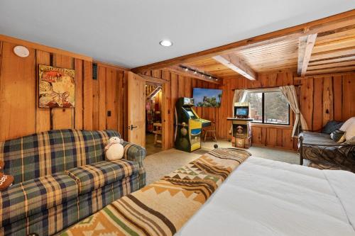 a living room with a bed and a couch at Modern Log Home-Walk2Slopes&Trails-Spa-Arcade-EVch in Big Bear Lake