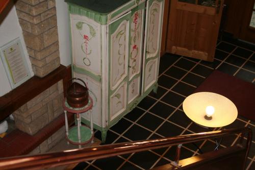 a small cabinet in a room with a table at Auberge du Lac in Xonrupt-Longemer