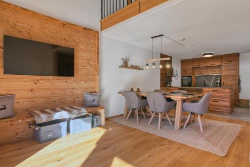 a kitchen and dining room with a table and chairs at Chalet Loferwinkl in Reit im Winkl