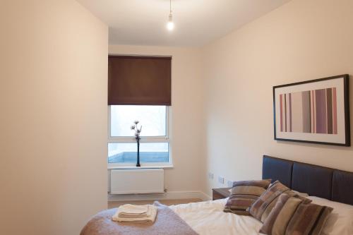 a bedroom with a bed and a window at PSF Panorama Apartments in Ashford