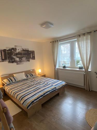 a bedroom with a large bed and a window at Rosemary Cottage in Solt