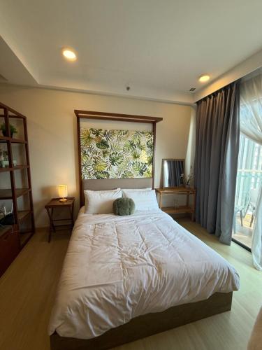 a bedroom with a large bed with a stuffed animal on it at Ecosea Timurbay in Kampong Tanjong