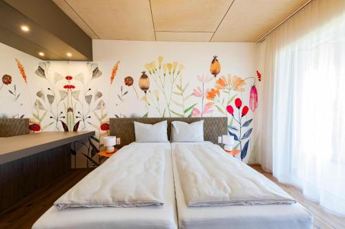 a bedroom with a large bed with a floral wallpaper at CIRCLE Boutique Hotel Melk in Melk