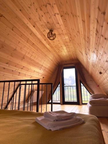 a room with a bed and a large window at Elia Hut Kazbegi in Kazbegi