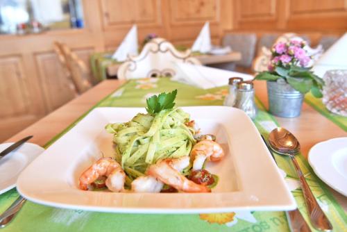 a plate of shrimp and vegetables on a table at Hotel Hirschen in Schluchsee