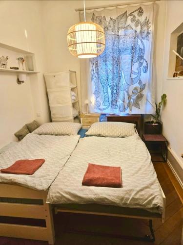 two twin beds in a room with a window at Lake apartment with terrace in Nidau