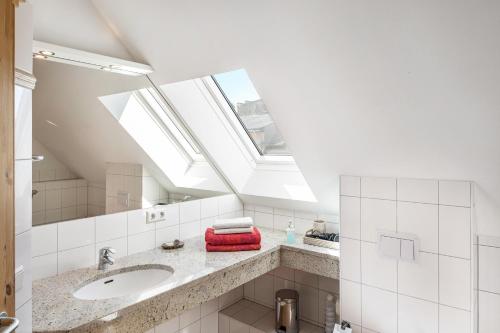 a bathroom with a sink and a skylight at Ferienhaus Haussee in Himmelpfort