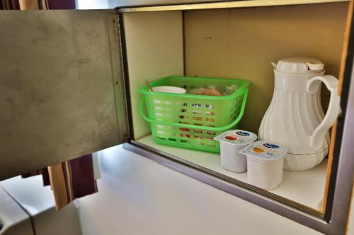a cupboard with a blender and other kitchen items at Nittany Budget Motel in State College