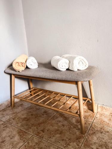 a bench with towels sitting on top of it at Boutique maison Filiatra in Filiatra