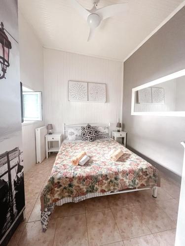 a bedroom with a bed with a floral bedspread at Boutique maison Filiatra in Filiatra