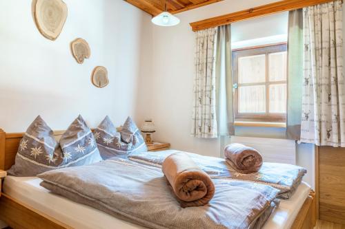 a bedroom with a bed with towels on it at Chalet Schintlbauer in Annaberg im Lammertal