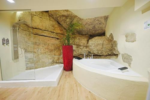 a bathroom with a tub and a sink with a plant at Respirar in Peniscola