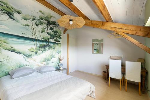 a bedroom with a large painting on the wall at Vacances chez Cali - Maison 10 pers in La Séguinière