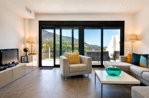 a living room with a couch and a tv at Mountain Villa with Pool by NRAS in Orcheta