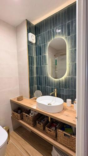 a bathroom with a sink and a mirror at El Minorq'In in Cala en Porter