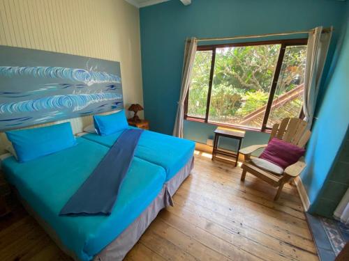 a bedroom with a blue bed and a window at BlueSkyMining in Kingsborough
