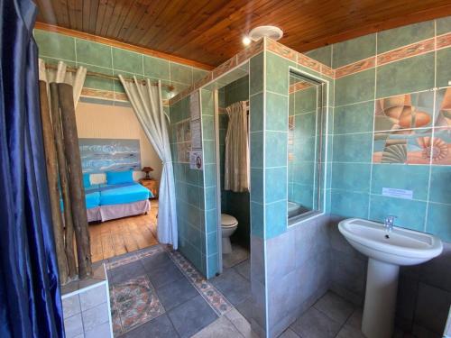 a bathroom with a shower and a sink and a toilet at BlueSkyMining in Kingsborough